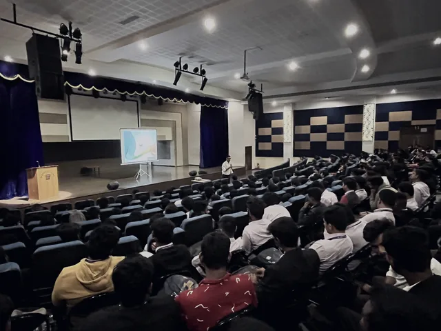 A full college auditorium during a financial literacy session